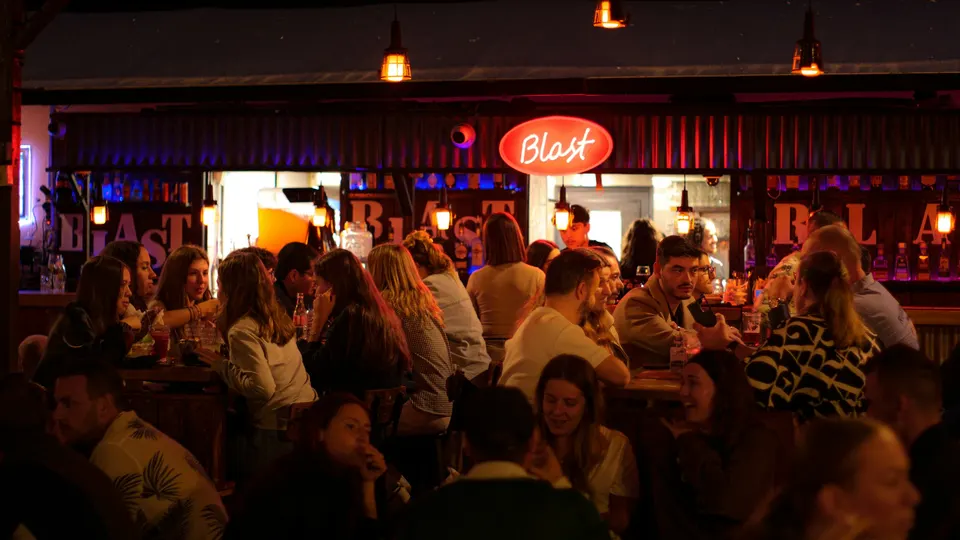 People gathered for a lively evening at a neon-lit bar
