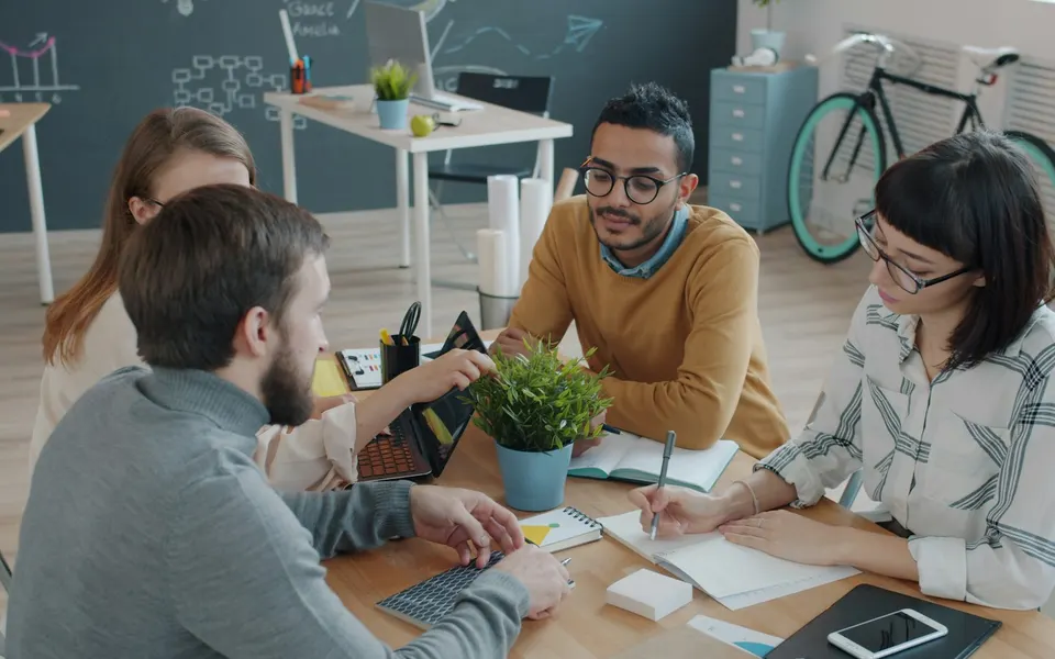 Colleagues sharing ideas around a table
