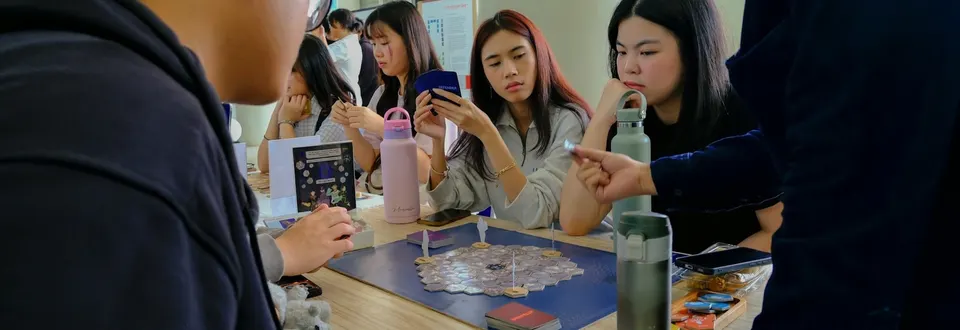A group of friends concentrating on a tabletop game together